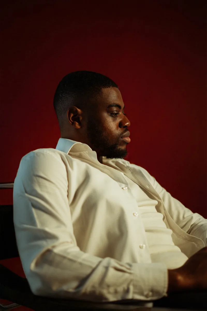 Portrait in profile against red wall