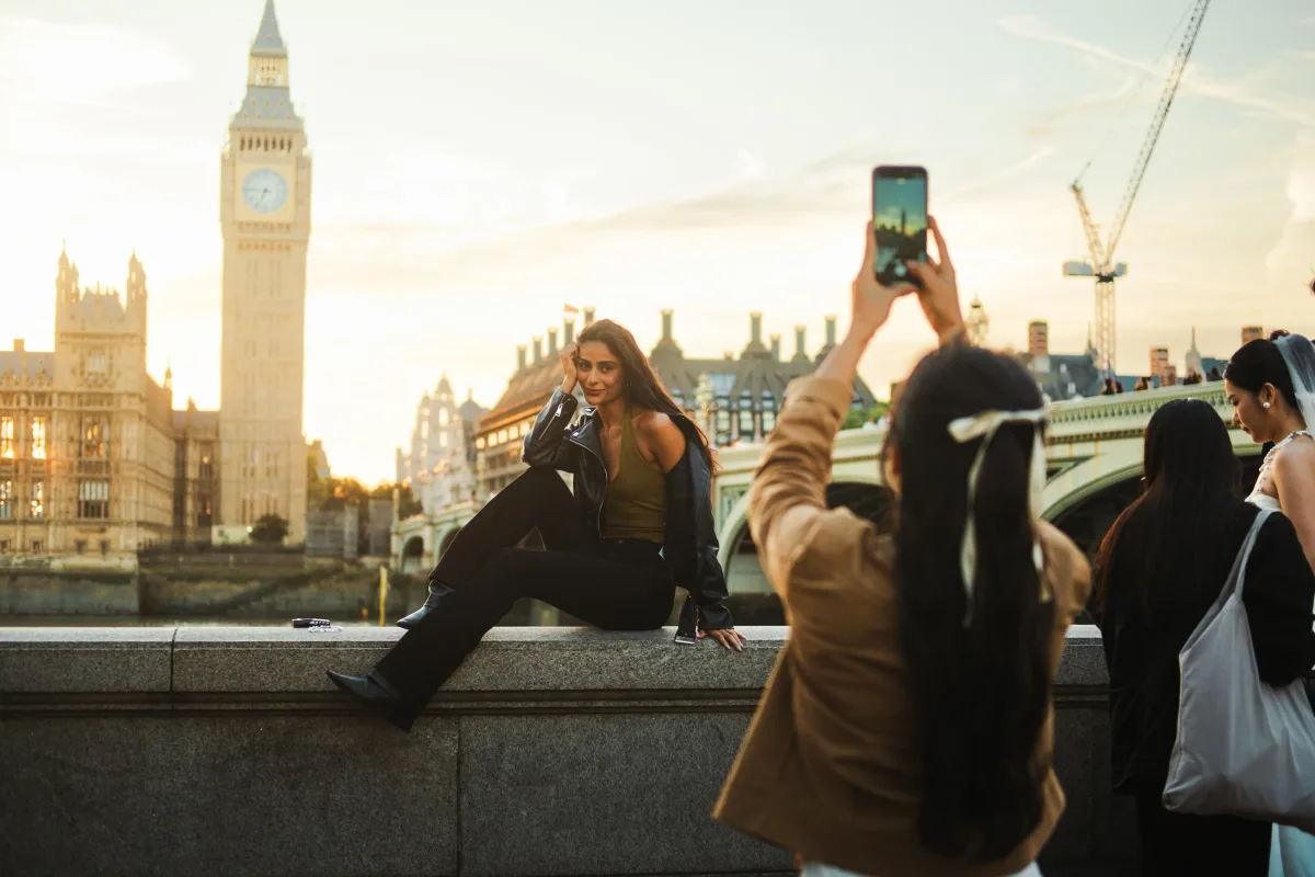 Posing for a photo by Big Ben at sunset